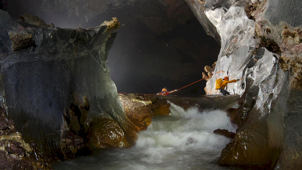 The underground river flows silently through the cave, adding to its mysterious allure